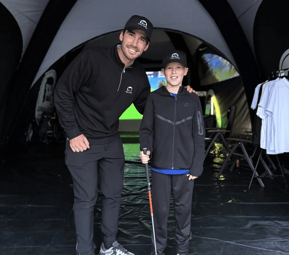 Jack Howard with a young customer at a SIMply Golf 365 pop-up
